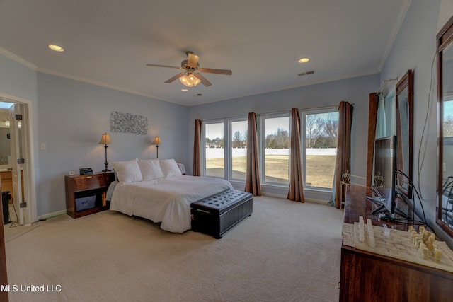 carpeted bedroom featuring ceiling fan and ornamental molding