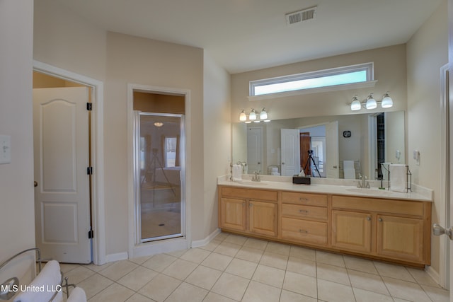 bathroom with tile patterned flooring, vanity, and an enclosed shower