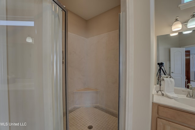 bathroom with vanity and a shower with shower door