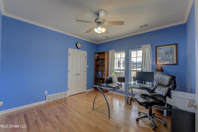 home office with ceiling fan, ornamental molding, and light wood-type flooring