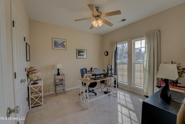 carpeted home office featuring ceiling fan