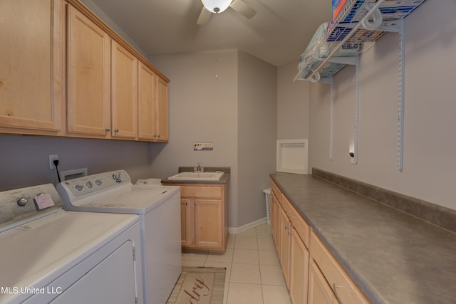 clothes washing area featuring cabinets, ceiling fan, sink, washer and dryer, and light tile patterned floors