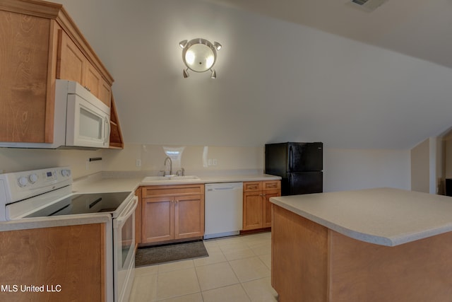 kitchen featuring white appliances, sink, and light tile patterned floors