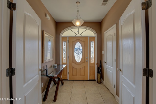 entryway with light tile patterned floors