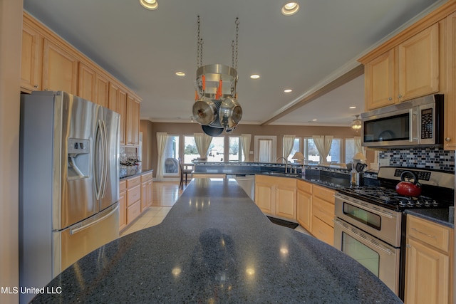 kitchen featuring kitchen peninsula, stainless steel appliances, and light brown cabinetry