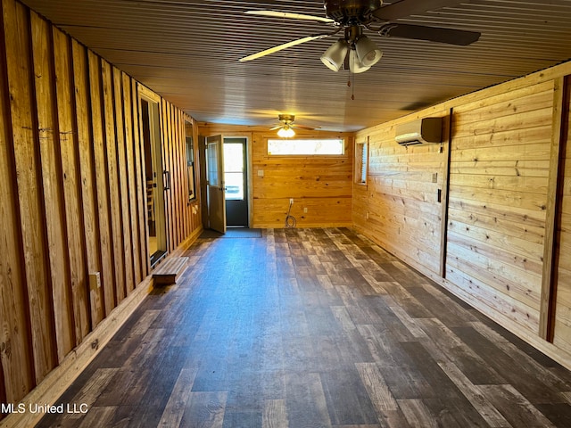 spare room featuring dark wood-type flooring, a wall mounted AC, and wooden walls