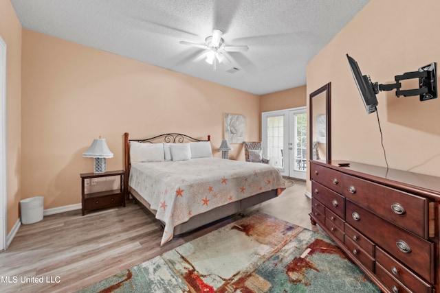 bedroom featuring ceiling fan, a textured ceiling, light hardwood / wood-style floors, and access to exterior