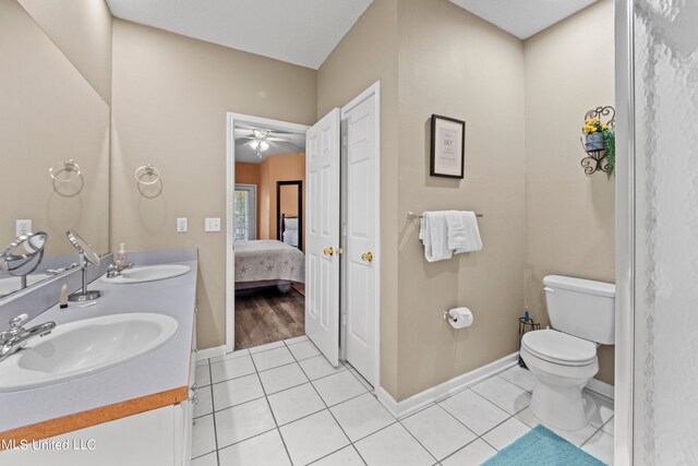 bathroom with vanity, toilet, tile patterned floors, and ceiling fan