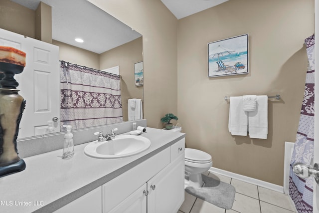 bathroom with vanity, toilet, and tile patterned floors