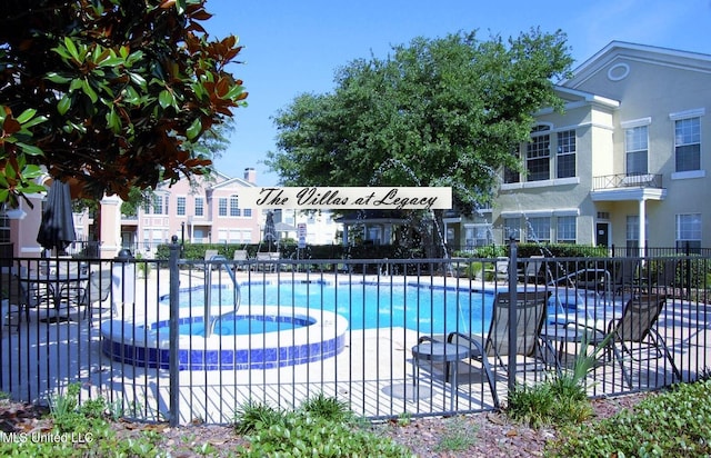 view of swimming pool with a community hot tub