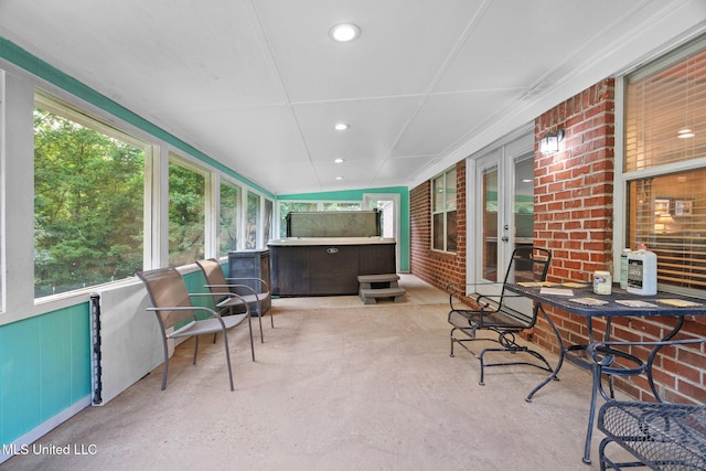 639 Plantation Way, Byhalia, MS 38611 - sunroom with french doors, a jacuzzi, brick wall, finished concrete flooring, and recessed lighting