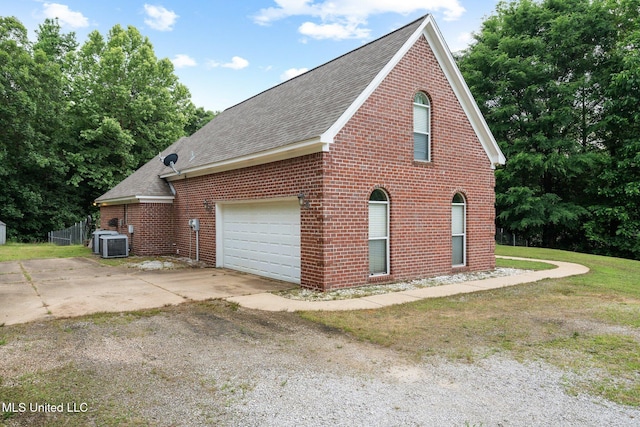 639 Plantation Way, Byhalia, MS 38611 - view of home's exterior with cooling unit, roof with shingles, a garage, and brick siding