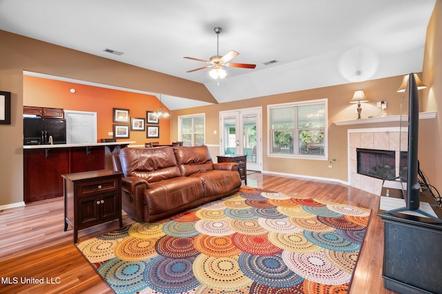 639 Plantation Way, Byhalia, MS 38611 - living area featuring a ceiling fan, light wood-style flooring, a fireplace, vaulted ceiling, and healthy amount of natural light