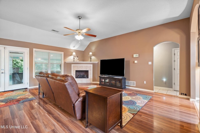 639 Plantation Way, Byhalia, MS 38611 - living area featuring arched walkways, ceiling fan, light wood finished floors, lofted ceiling, and a fireplace