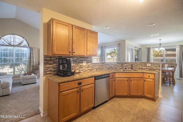 1574 Rachel Dr, Biloxi, MS 39532 - kitchen with stainless steel dishwasher, plenty of natural light, a peninsula, a chandelier, and a textured ceiling