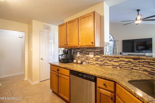 1574 Rachel Dr, Biloxi, MS 39532 - kitchen with stainless steel dishwasher, tasteful backsplash, ceiling fan, light stone countertops, and a textured ceiling
