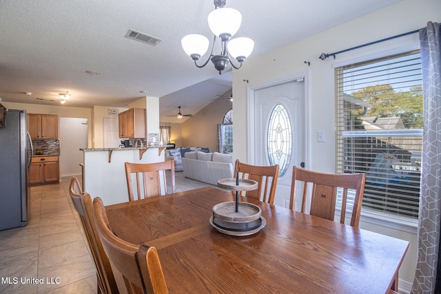 1574 Rachel Dr, Biloxi, MS 39532 - dining room with a chandelier, a ceiling fan, light tile patterned floors, and a textured ceiling