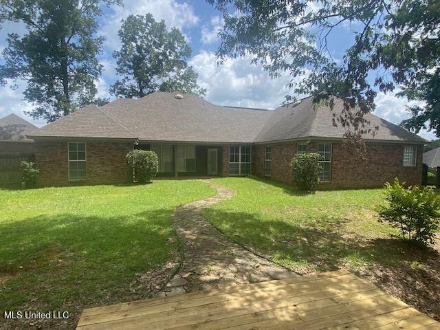309 Barrington Cv, Byram, MS 39272 - rear view of house with a lawn and a deck