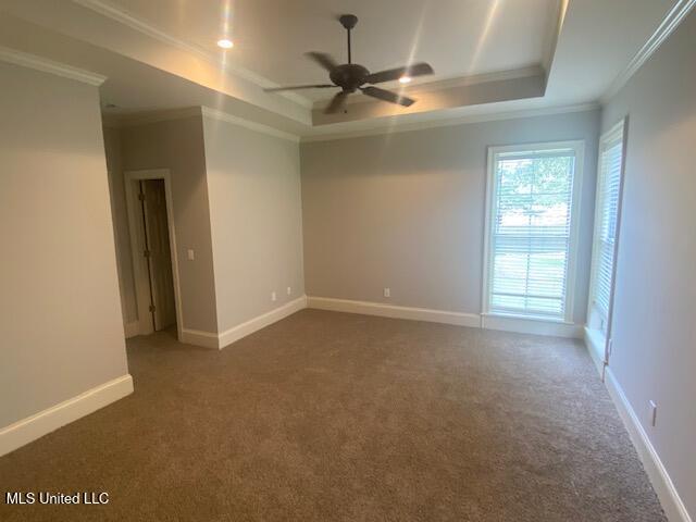 309 Barrington Cv, Byram, MS 39272 - carpeted empty room featuring crown molding, ceiling fan, and a raised ceiling