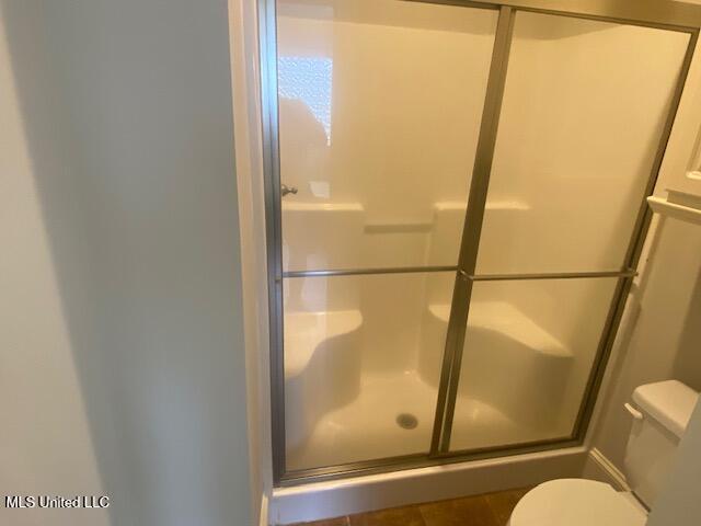 309 Barrington Cv, Byram, MS 39272 - full bath featuring toilet and an enclosed shower