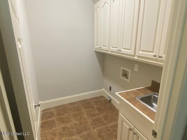 309 Barrington Cv, Byram, MS 39272 - washroom with washer hookup and cabinet space