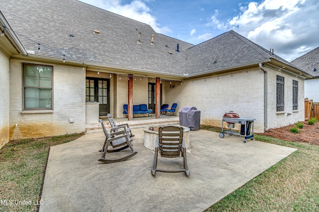 view of patio with an outdoor living space with a fire pit