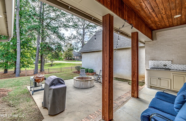 view of patio featuring area for grilling and an outdoor fire pit