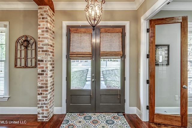 entryway with dark wood-type flooring, a wealth of natural light, and french doors