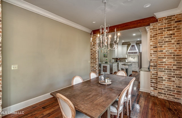 dining space with a notable chandelier, dark hardwood / wood-style flooring, and ornamental molding