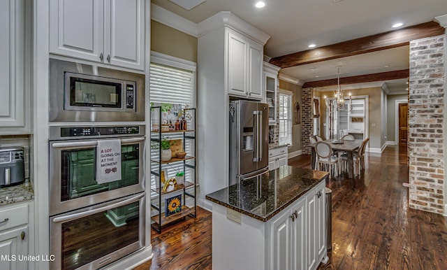 kitchen featuring a healthy amount of sunlight, dark wood-type flooring, white cabinets, and stainless steel appliances