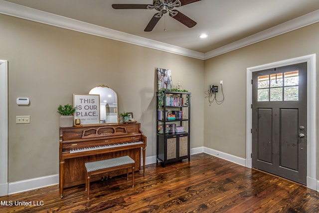 foyer entrance with ceiling fan, crown molding, and dark wood-type flooring