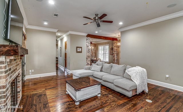 living room with dark hardwood / wood-style floors, a brick fireplace, ceiling fan, and crown molding