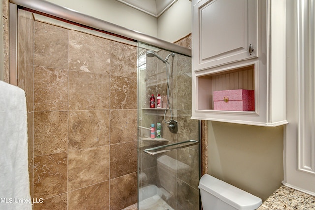 bathroom with toilet and walk in shower