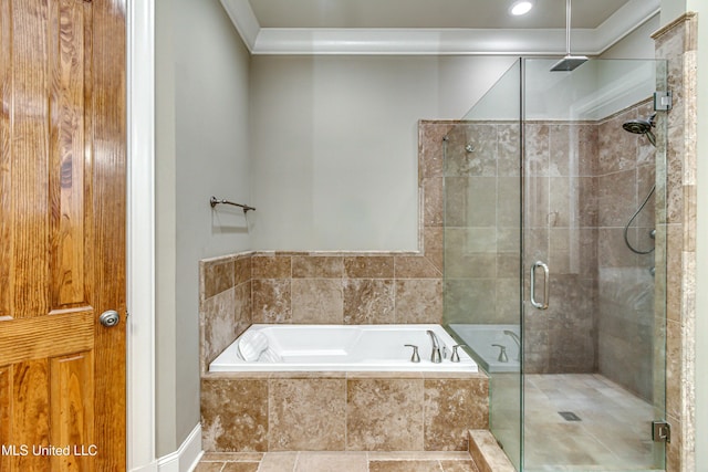 bathroom featuring ornamental molding and shower with separate bathtub