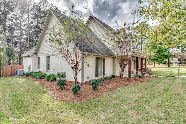 view of home's exterior featuring a lawn and central AC unit