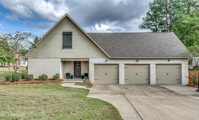 view of front of home featuring a garage and a front lawn