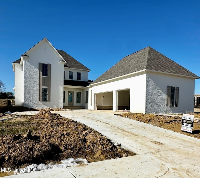 135 Genoa Dr, Madison, MS 39110 - view of front of property featuring a garage, driveway, and stucco siding