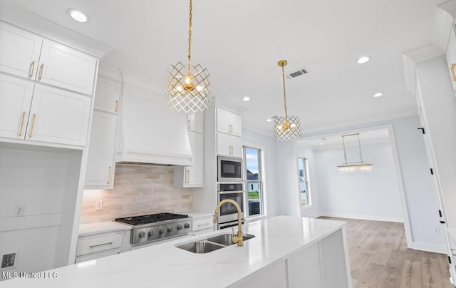 135 Genoa Dr, Madison, MS 39110 - kitchen with stainless steel appliances, decorative backsplash, white cabinets, recessed lighting, and light wood finished floors