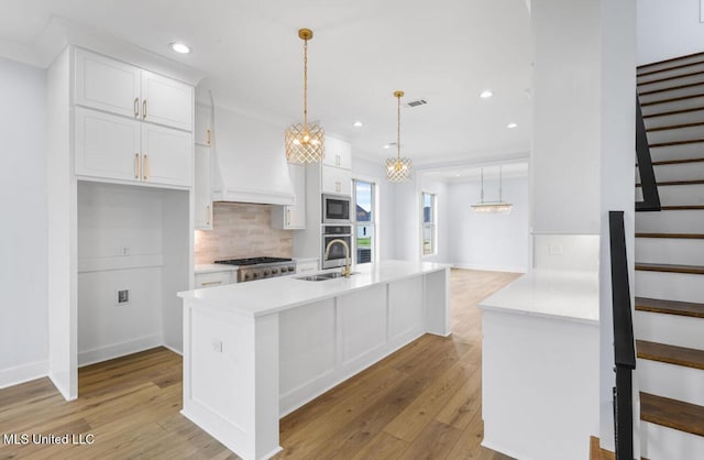 135 Genoa Dr, Madison, MS 39110 - kitchen with appliances with stainless steel finishes, backsplash, white cabinetry, light countertops, and recessed lighting
