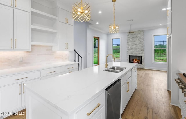 135 Genoa Dr, Madison, MS 39110 - kitchen featuring open floor plan, tasteful backsplash, wood finished floors, a stone fireplace, and white cabinets