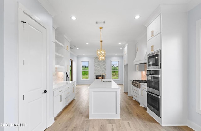 135 Genoa Dr, Madison, MS 39110 - kitchen with appliances with stainless steel finishes, recessed lighting, white cabinetry, light countertops, and light wood-style flooring