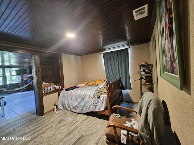 633 24th St, Gulfport, MS 39501 - bedroom featuring a textured wall, wood finished floors, and wooden ceiling