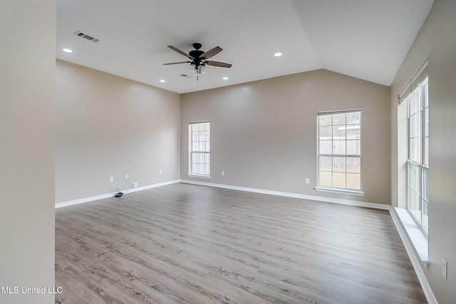 empty room with vaulted ceiling, light hardwood / wood-style floors, and ceiling fan