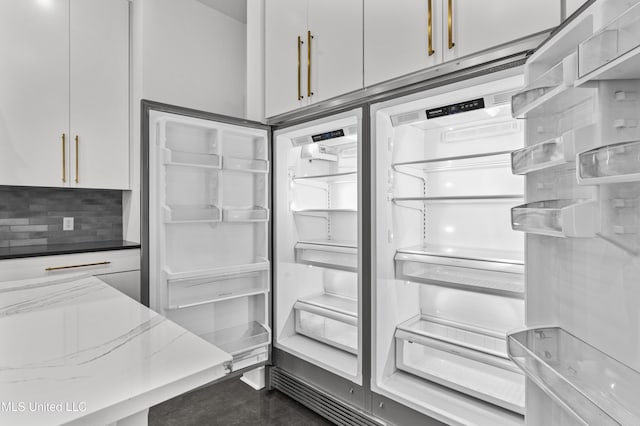 room details with built in fridge, open shelves, backsplash, white cabinets, and light stone countertops