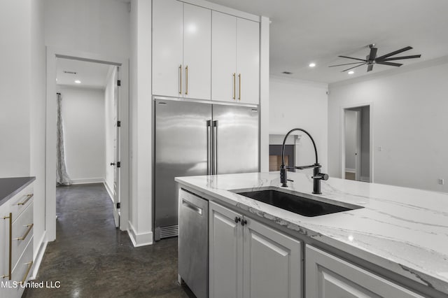 kitchen with recessed lighting, a sink, white cabinetry, appliances with stainless steel finishes, and finished concrete floors