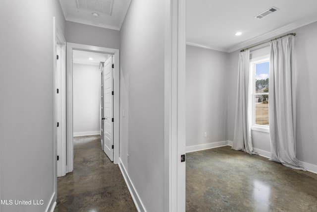 hallway featuring baseboards, finished concrete floors, visible vents, and ornamental molding