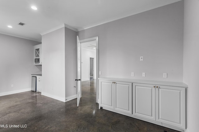 spare room with recessed lighting, visible vents, finished concrete floors, ornamental molding, and baseboards