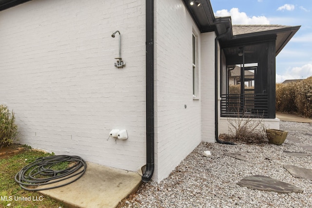 view of side of home with brick siding