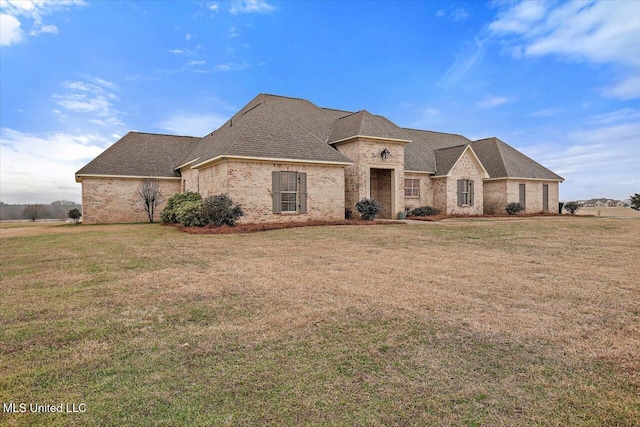 french provincial home featuring a front lawn