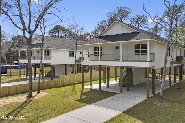 view of home's community featuring a carport, a lawn, stairs, and fence